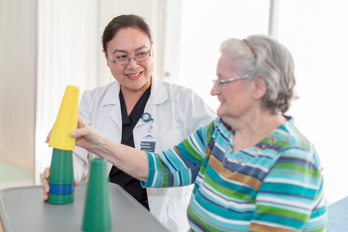 A therapist helping an elderly woman at Stoney Point
