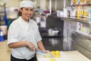A chef cutting lemons