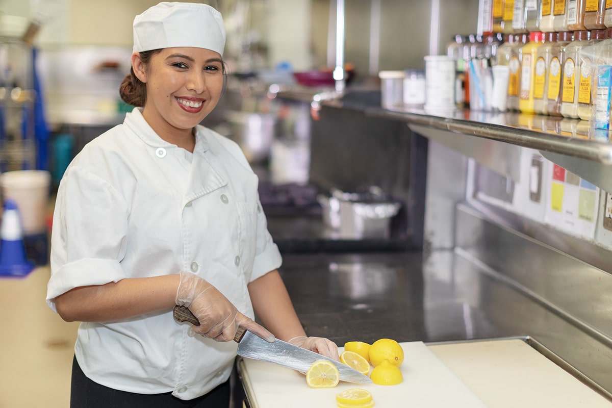 A chef cutting lemons